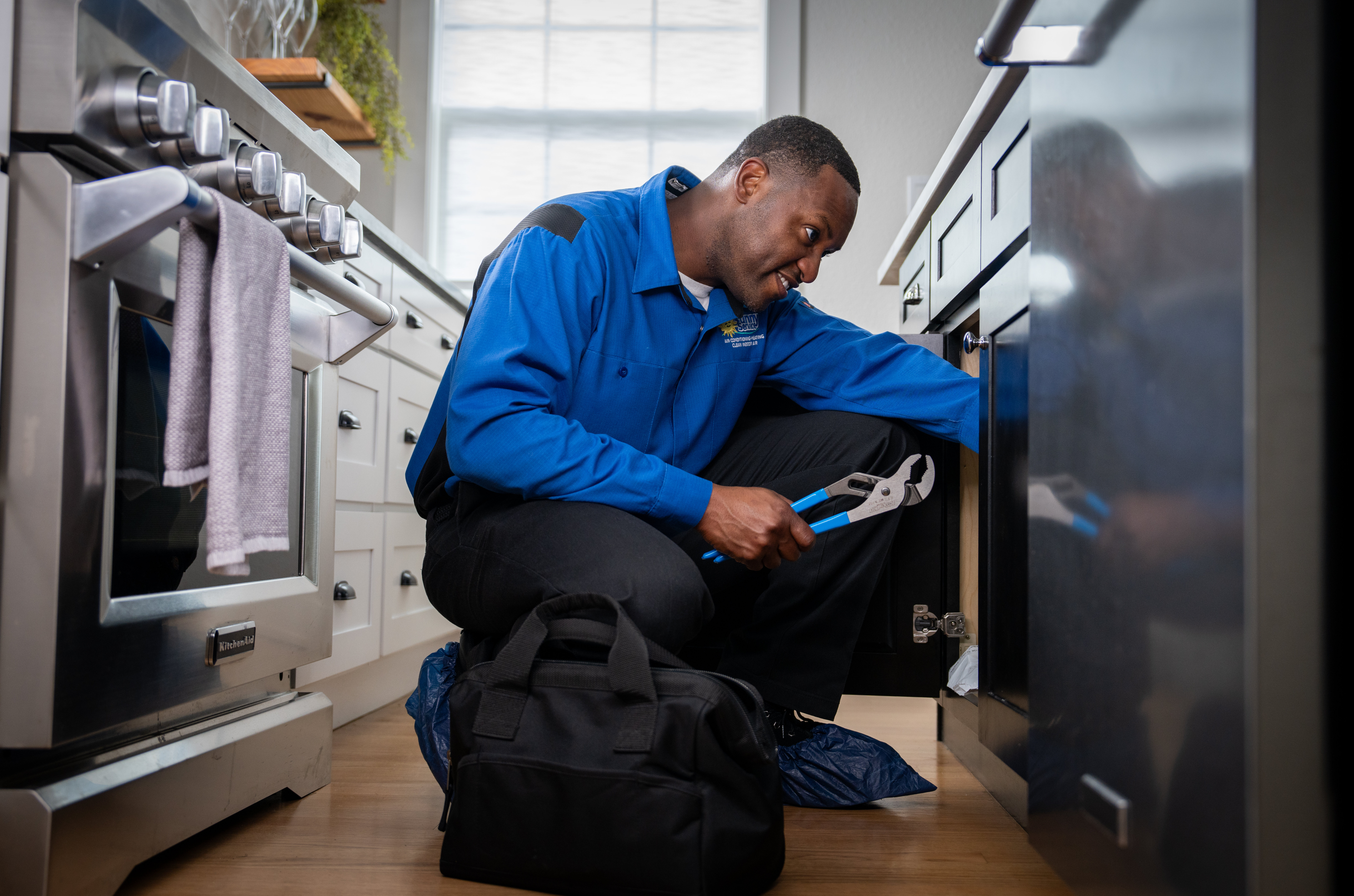 plumber repairing frozen pipe
